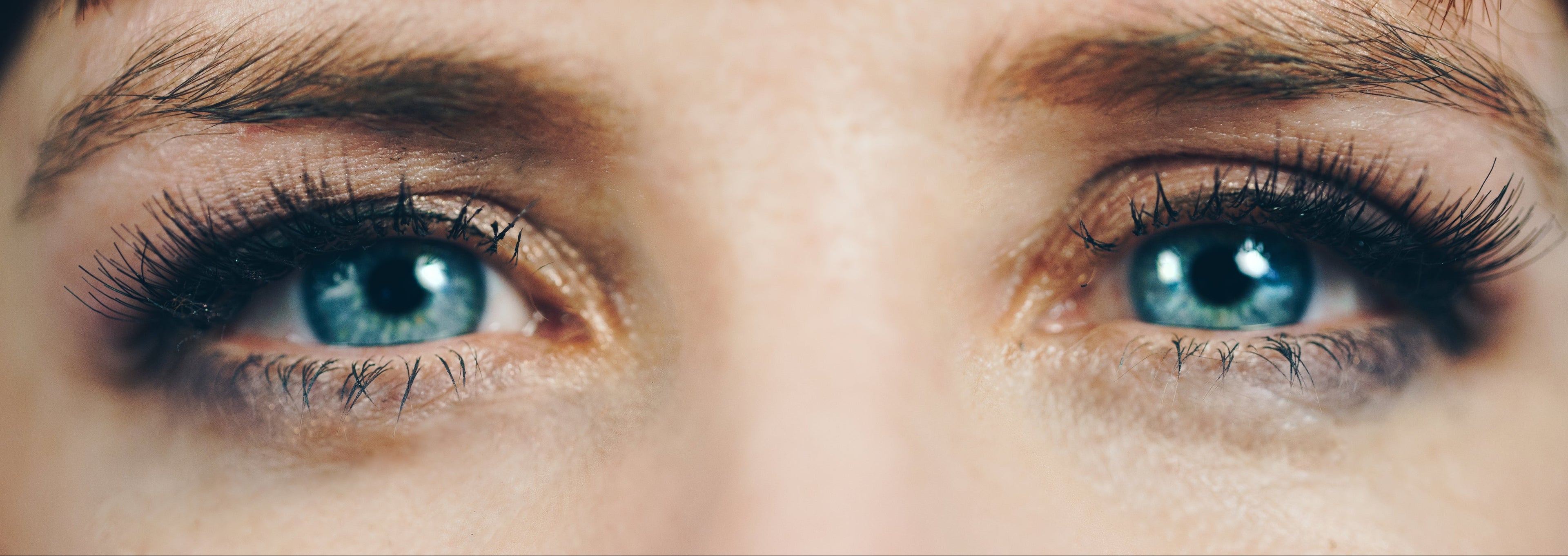 Close-up of a person's face with blue eyes